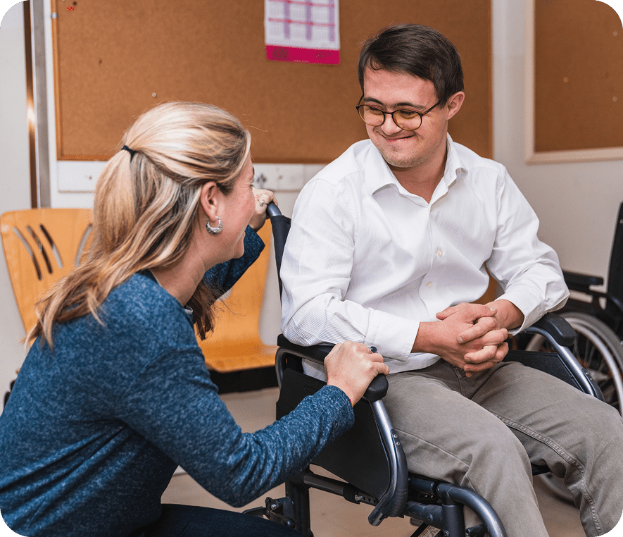 Two people smiling and talking