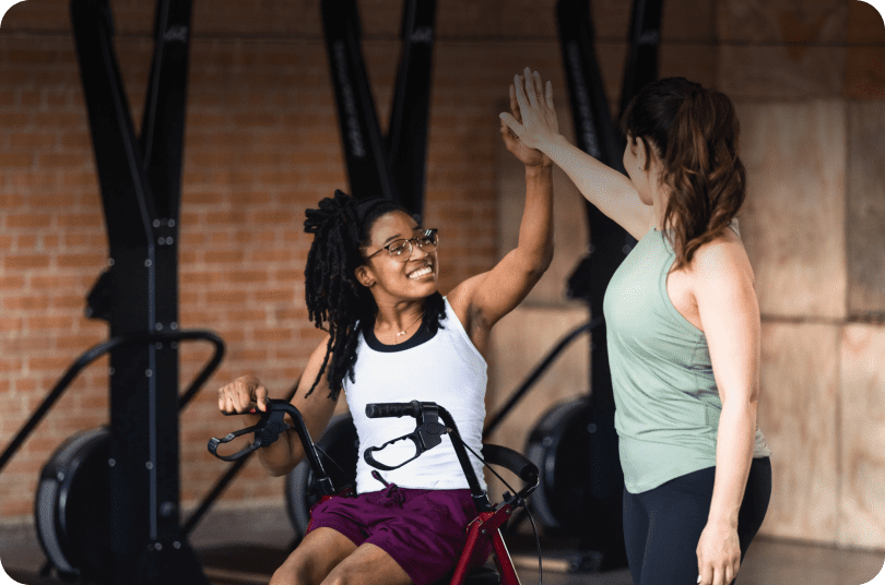 Two women celebrating at gym