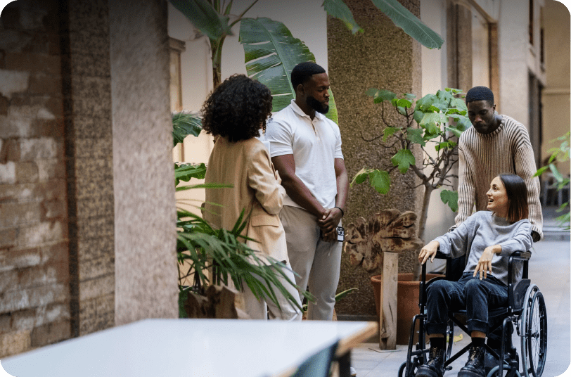 People socializing near potted plants